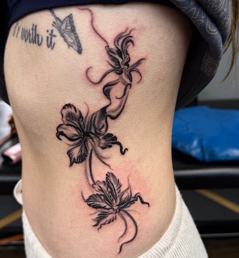 alt="Black & grey realism sleeve tattoo by Omar Barron, luxury custom tattoo Idaho"