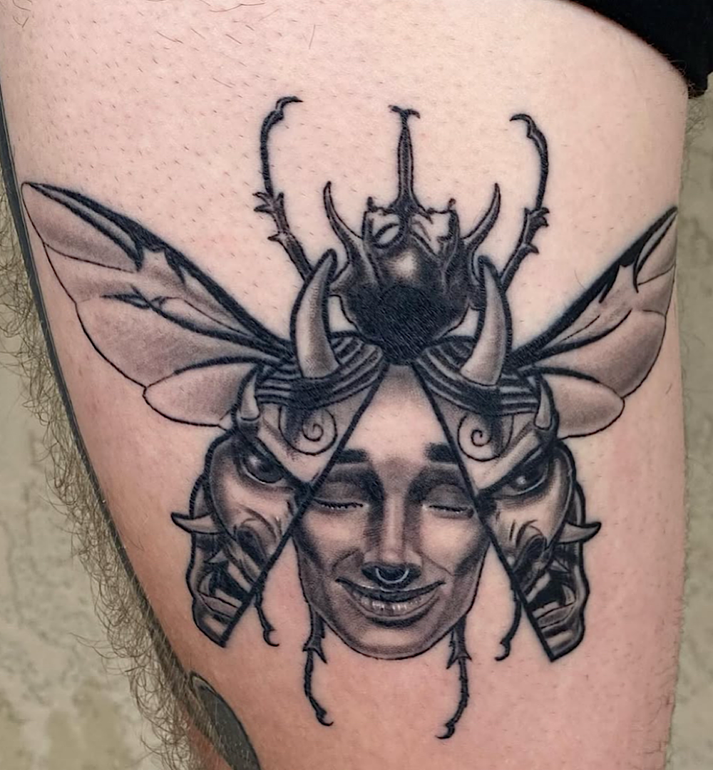 Healed black and grey realism beetle tattoo showing healed detail retention