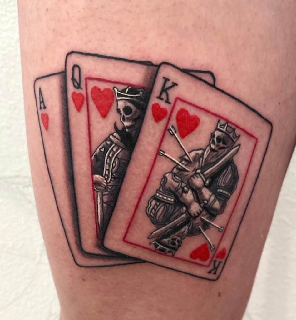 alt="Black & grey realism cards tattoo by Omar Barron, luxury custom tattoo Idaho"