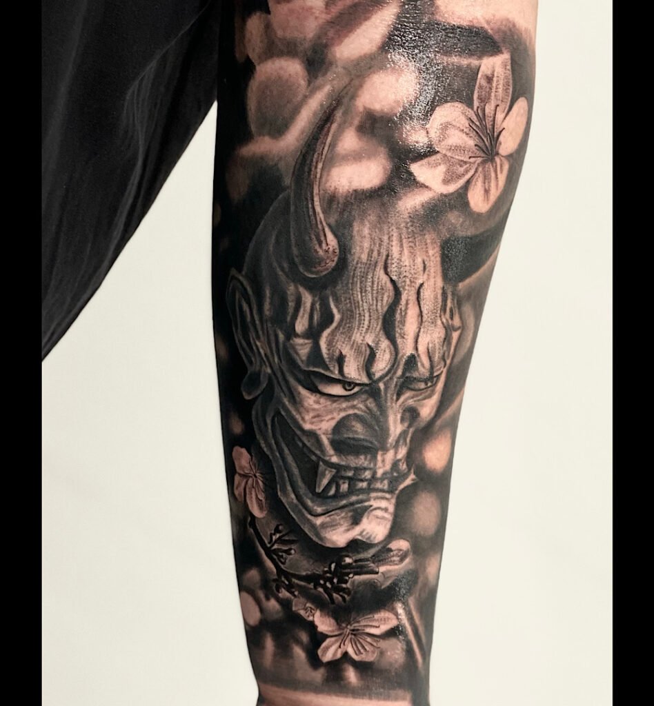 alt="Black & grey realism sleeve tattoo by Omar Barron, luxury custom tattoo Idaho"