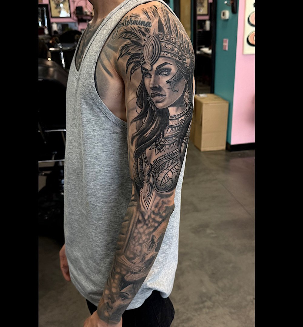 Black and grey realism sleeve tattoo by Omar Barron