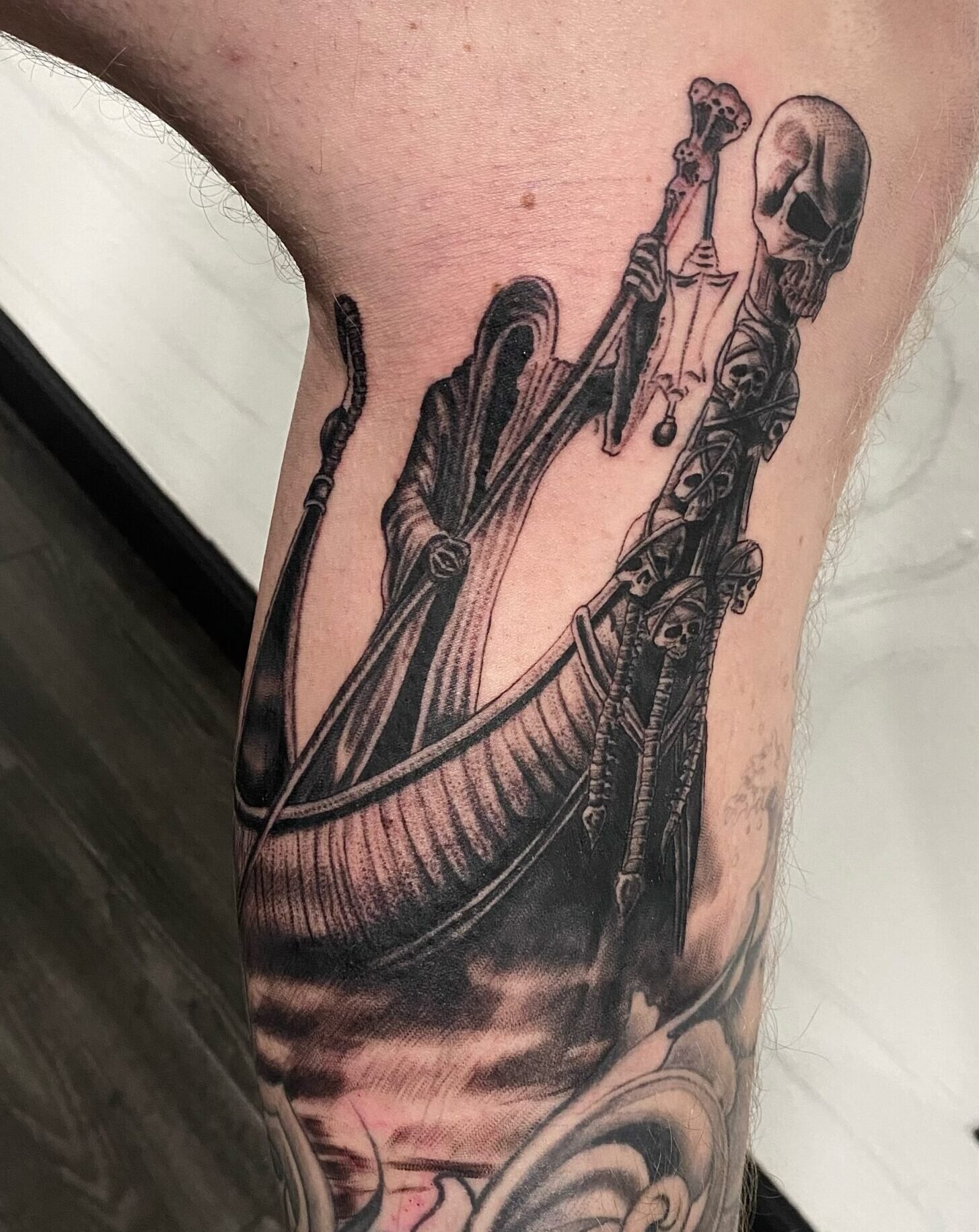 Fresh black and grey death tattoo showing detail and contrast