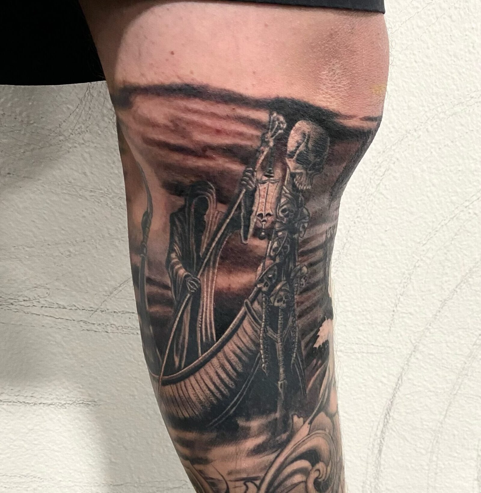 Healed black and grey death tattoo showing healed detail retention and added work